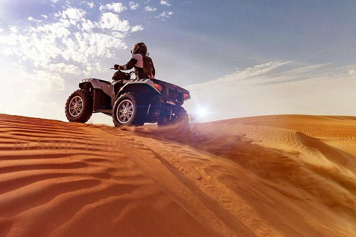Experience the rush of racing over golden dunes on a quad bike surrounded by stunning desert landscapes creating unforgettable memories in the heart of Dubai’s magnificent wilderness.